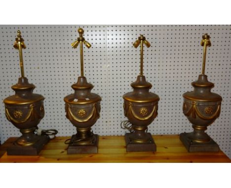 Lighting comprising; a set of four 20th century pottery table lamps of urn form and gilt swag decoration, (4). M10