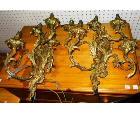 Lighting comprising; a pair of 20th century five branch gilt metal wall lights in the Rococo style, (2).  J10