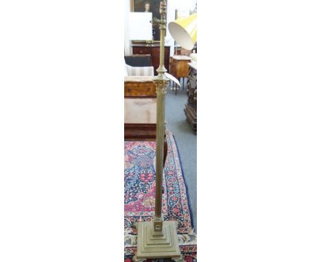 A Victorian style adjustable brass standard lamp, 20th century, of Corinthian column form, on four lion's paw feet.