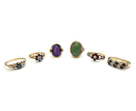 A gold ring, mounted with an oval cabochon jade, detailed 14 K, a gold ring, mounted with an oval cut amethyst, detailed 585,