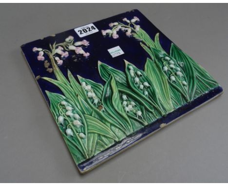 A George Jones majolica tile, circa 1870, moulded with lily of the valley against a cobalt blue ground, black painted number 