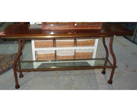 A 20th century metal console table, with mahogany top and brass edges, with glass undertier shelf, 140cm wide x 76cm high.  H