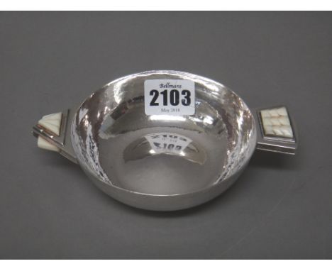 A silver and ivory mounted circular two handled nut dish, with an arrow head and arrow feathers design to the handles, by R.E