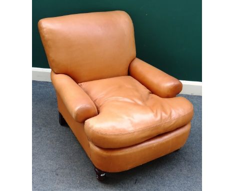 A 20th century light tan leather upholstered easy armchair, with bow seat on turned mahogany supports, 85cm wide x 82cm high.