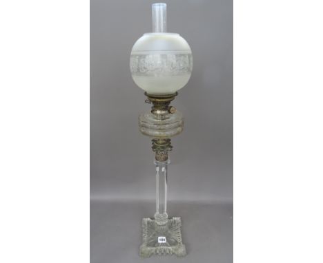 A Victorian cut glass oil lamp, on a heavy square shaped foot with hexagonal column, Corinthian metal capital, faceted circul