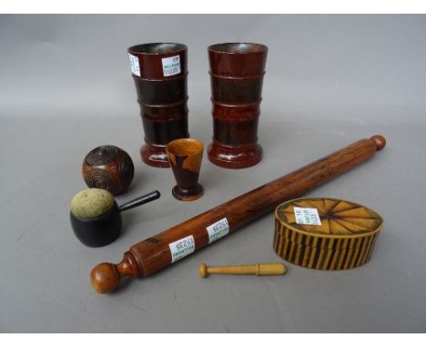 A group of small treen collectables, comprising; a parquetry inlaid oval trinket box, 7cm wide, a circular pen case, a novelt
