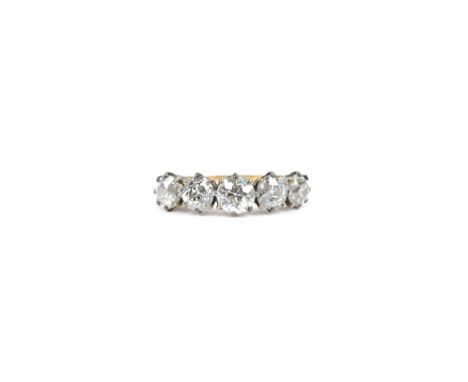 A gold and diamond five stone ring, claw set with a row of cushion shaped diamonds, ring size M, with a case.   Illustrated