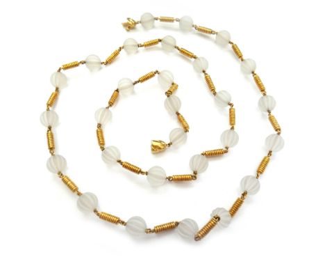 A gold and rock crystal necklace, designed as a single row of melon fluted spherical rock crystal beads, with ridged baton sh
