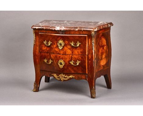 A diminutive Louis XV style commode, circa 1900, the serpentine marble top over a gilt metal mounted marquetry inlaid Kingwoo