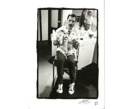 Queen - Original 10 x 8 inch Black and white silver gelatin print showing Freddie Mercury holding a promoters dog with a 'Fre