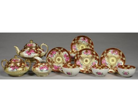 A JAPANESE NORITAKE STYLE TEA SERVICE, PAINTED WITH CABBAGE ROSES RESERVED ON A PRIMROSE AND RICHLY GILT GROUND WITH DEEP RED