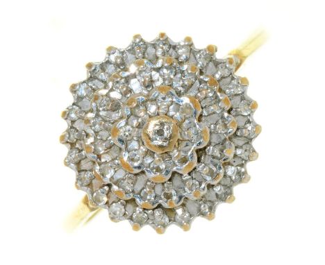 A DIAMOND CLUSTER RING OF TIERED DESIGN, IN 9CT GOLD, LONDON 1991, 2.5G, SIZE M Crown worn from use, hoop with light wear