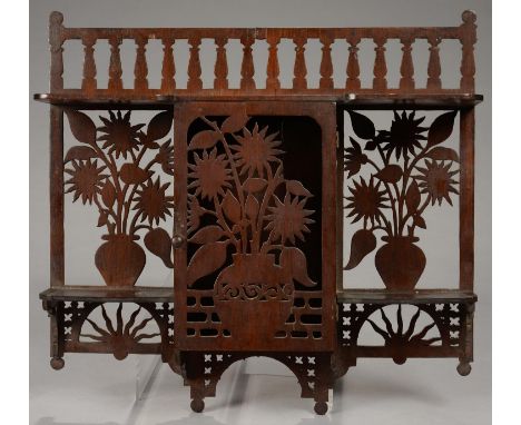 AN AESTHETIC MOVEMENT FRETWORK MURAL CUPBOARD, DECORATED WITH FLOWERS AND RISING SUN, 40CM L, C1880 Lacking shoot and two lea