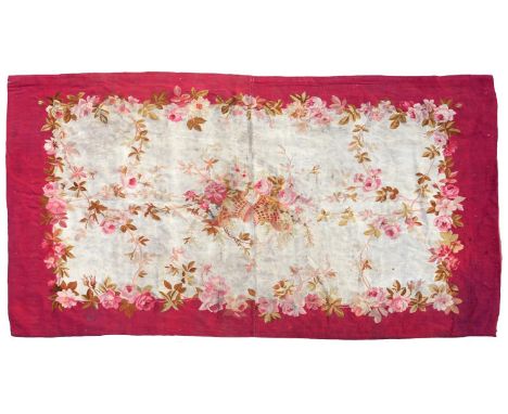 AN AUBUSSON TAPESTRY RUG ADAPTED FROM THE UPPER HALVES OF A PAIR OF PORTIERES, C1900, WITH FLOWER FILLED BASKETS, 120 X 226CM