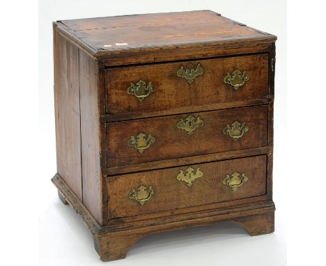 A GEORGE III OAK DWARF CHEST OF DRAWERS WITH BRASS HANDLES, ON BRACKET FEET, 71CM H; 64 X 55CM Numerous chips, losses and cra