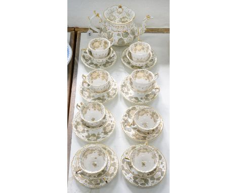 A ROCKINGHAM TEA AND COFFEE SERVICE OF SINGLE SPUR HANDLE SHAPE, WITH TEAPOT OF THREE SPUR HANDLE SHAPE, DECORATED WITH FLOWE