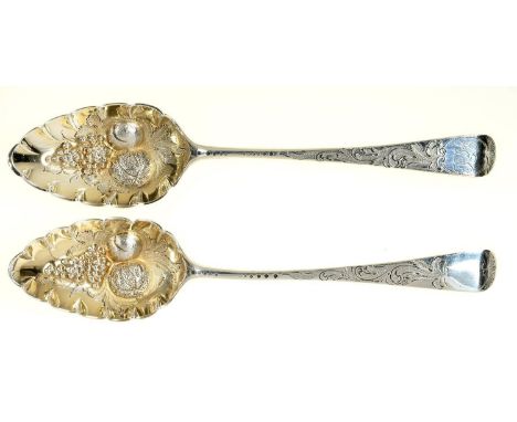 A PAIR OF GEORGE III SILVER TABLE SPOONS, LATER CHASED AND GILT AS BERRY SPOONS, ONE ENGRAVED WITH INITIALS, MAKER GB, LONDON