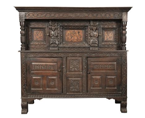 AN ANTIQUARIAN TASTE CARVED OAK LIVERY CUPBOARD, 17TH C AND LATER, THE CENTRE PANEL AND THOSE TO THE DOORS INLAID IN BOG OAK 