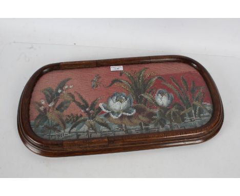 A glazed bead and wool work panel, with a mahogany surround, 56cm by 30cm&nbsp;&nbsp;