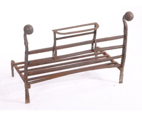 A cast iron fire grate, with orb finials, four bar front and detachable bracket, 68cm wide, 40cm deep, 49.5cm high