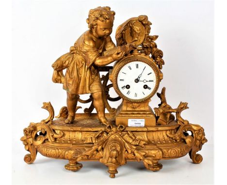 French gilt metal mantle clock, decorated with a young child reading a book, the white dial with Roman numerals, movement sig