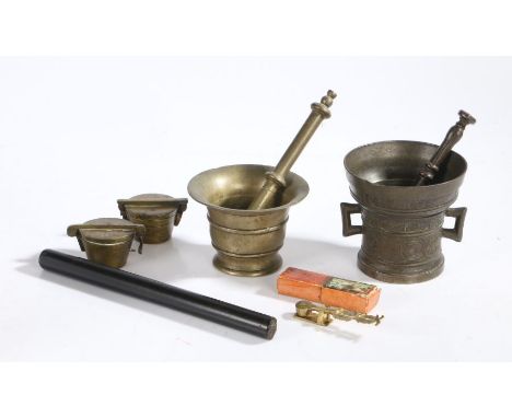 Two brass pestles and mortars, two cased sets of Nuremberg weights, ebony draughtsman's rule, set of sovereign scales (5)&nbs