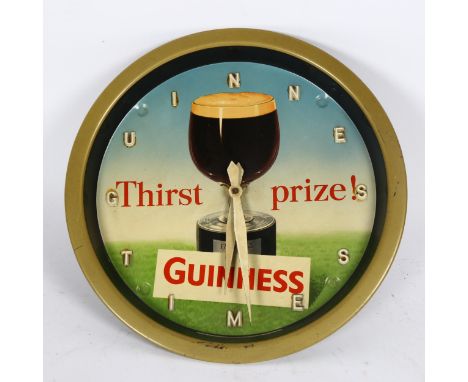 A Vintage Guinness Time Thirst prize wall clock, printed by Reginald Corfield Ltd, with pine cone weight, diameter 27cmNo dam