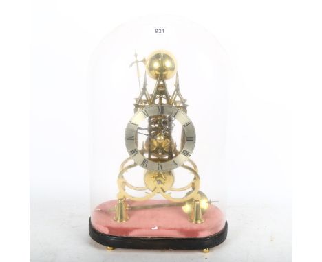 A reproduction brass skeleton clock in Gothic architectural design, striking on a bell, under glass dome, height 44cm 