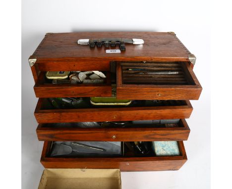 A Vintage tool chest or engineer's cabinet, drawers are full of small tools and various instruments, on key or handles presen