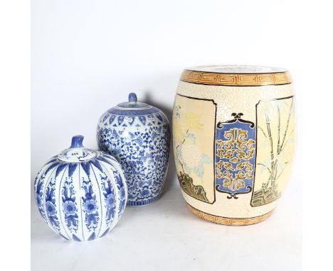 A ceramic Oriental garden seat, 42cm, and 2 blue and white jars and covers 