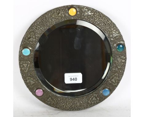 An Arts & Crafts circular pewter wall mirror, with polychrome Ruskin enamel bosses, overall diameter 24cm 