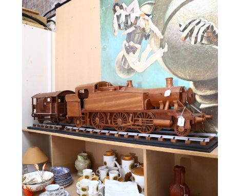 A large scratch-built wooden steam engine and carriage, and 2 sections of track, steam engine length 106cm 