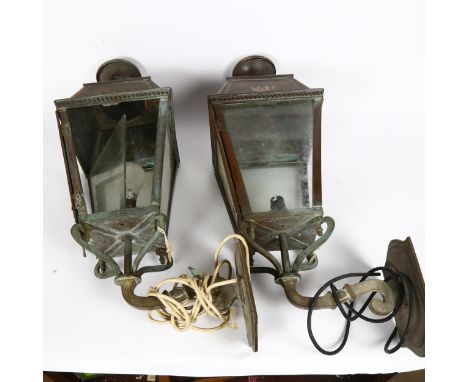A pair of Victorian copper-framed wall lanterns, with embossed VR cypher, overall height 64cm, lantern height 42cmNo damage o