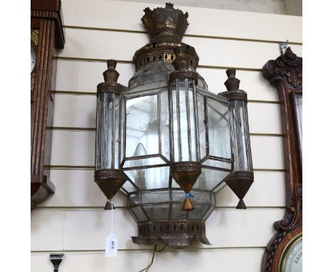 A Moroccan pressed metal glass-panelled wall light with mirrored back, height 70cm (1 glass panel broken) 