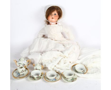 Vintage doll's tea set with Snow White theme, and a German Spezial porcelain-headed doll with jointed limbs, height 54cm 