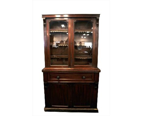 A large Victorian two-tier mahogany secretaire bookcase, the top with scrolled applied mounts, flanking a pair of panelled gl