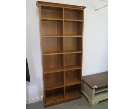 A reproduction light oak effect tall twin open book case with ten adjustable shelves, 214cm H, 99cm W, 28cm D at top - in goo