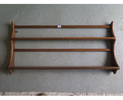 An Ercol wall hanging shelf, with two shelves, Ercol stamp to one side, approximately 97cm wide, 50cm high 