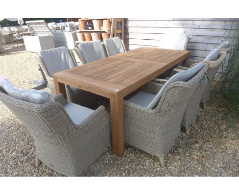 A Bramblecrest Batu vintage teak table with eight Oakridge high back armchairs