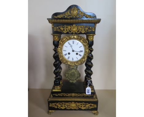 A 19th Century French Portico clock 8 day movement ebonised case, barley twist pillars with brass gilding, strikes hours/half