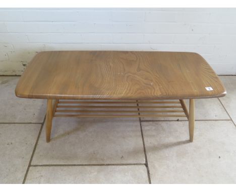 An Ercol elm coffee table - 37cm H x 105cm x 46cm - small stains to top, otherwise good