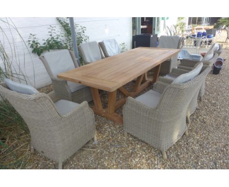 A Bramblecrest Kuta vintage teak table with eight Oakridge high back armchairs 