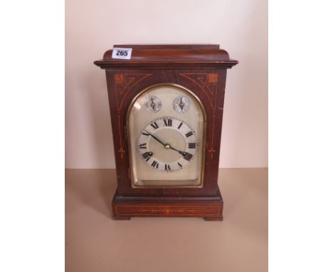 A German mantle clock in a walnut case, chiming on four rods - 35cm tall, in running order 