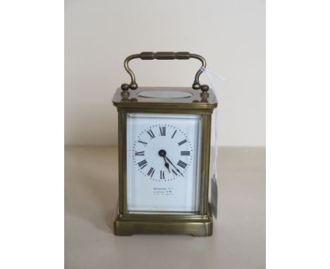 A brass French carriage clock, retailed by Harrods London with Key 