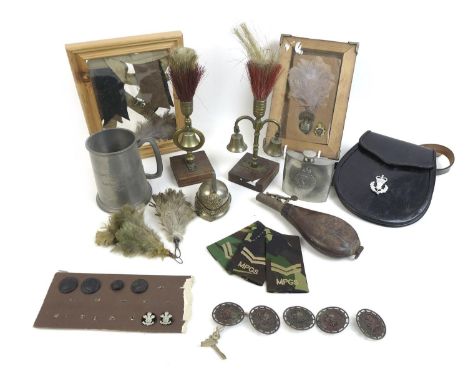 A group of military related items, including a Royal Inniskilling Fusiliers cap badge and feather, mounted and framed, a leat