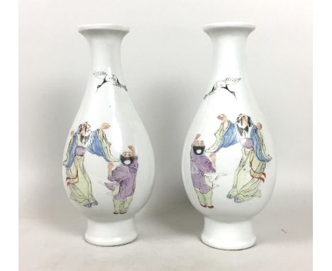 A pair of Chinese early 20th century famille rose porcelain vases, of inverted baluster form with flared rim and high spreadi