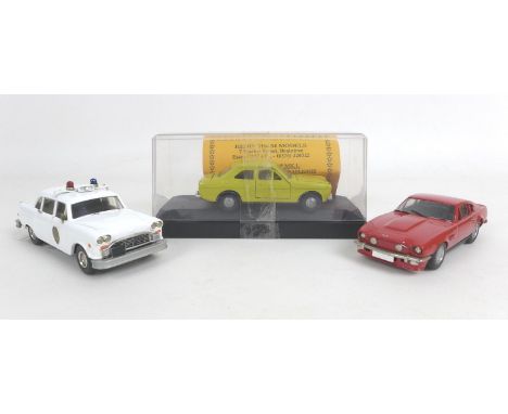 Three 1/43 scale die-cast models cars, a limited edition Ford Escort Mk.1 in yellow from Hedingham Models with certificate nu