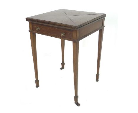 An Edwardian mahogany envelope card table, with a single drawer, raised upon tapered legs upon castors, 54 by 54 by 75cm high