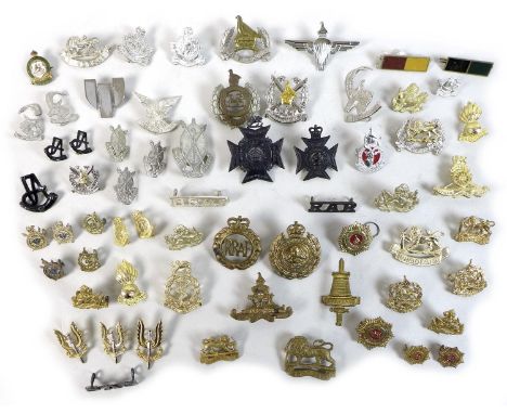 A group of fifty five British and Rhodesian army badges and buttons, replicas and originals, including SAS, Parachute regimen