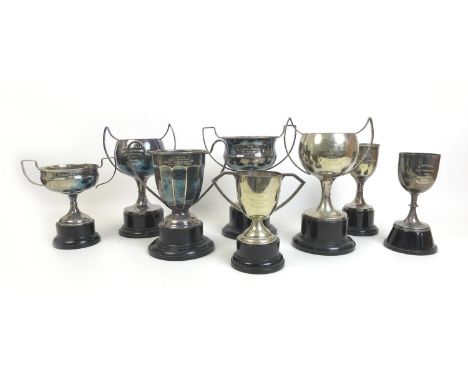 A group of eight 1930s British army silver plated sporting trophies, all with circular wooden or plastic plinths, comprising 